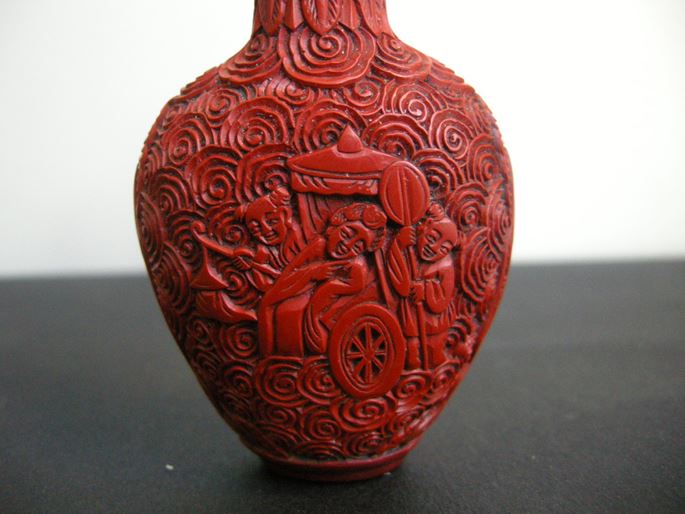 Cinnabar lacque snuff bottle on metal decorated and sculpted with a rider on one side and characters on a trolley on the other | MasterArt